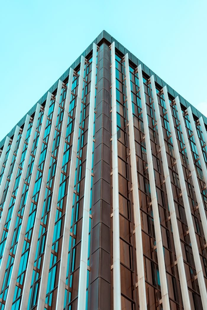 Corner view of a contemporary glass skyscraper in Madrid, showcasing modern architecture.