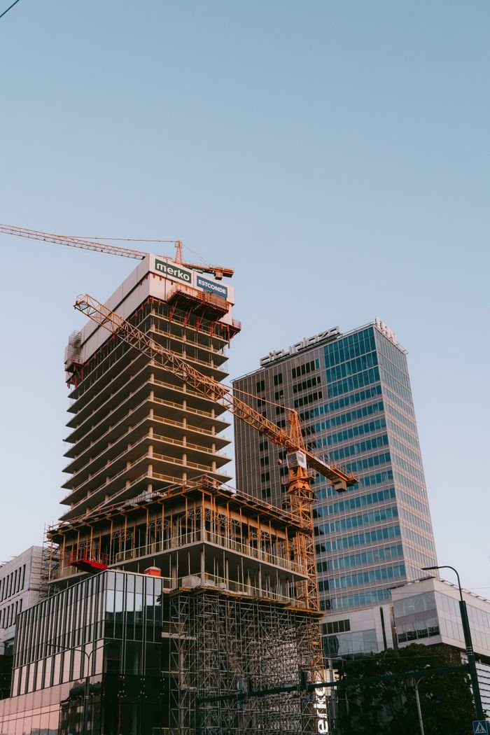 Modern architecture in Tallinn's city center featuring cranes and skyscrapers under construction.